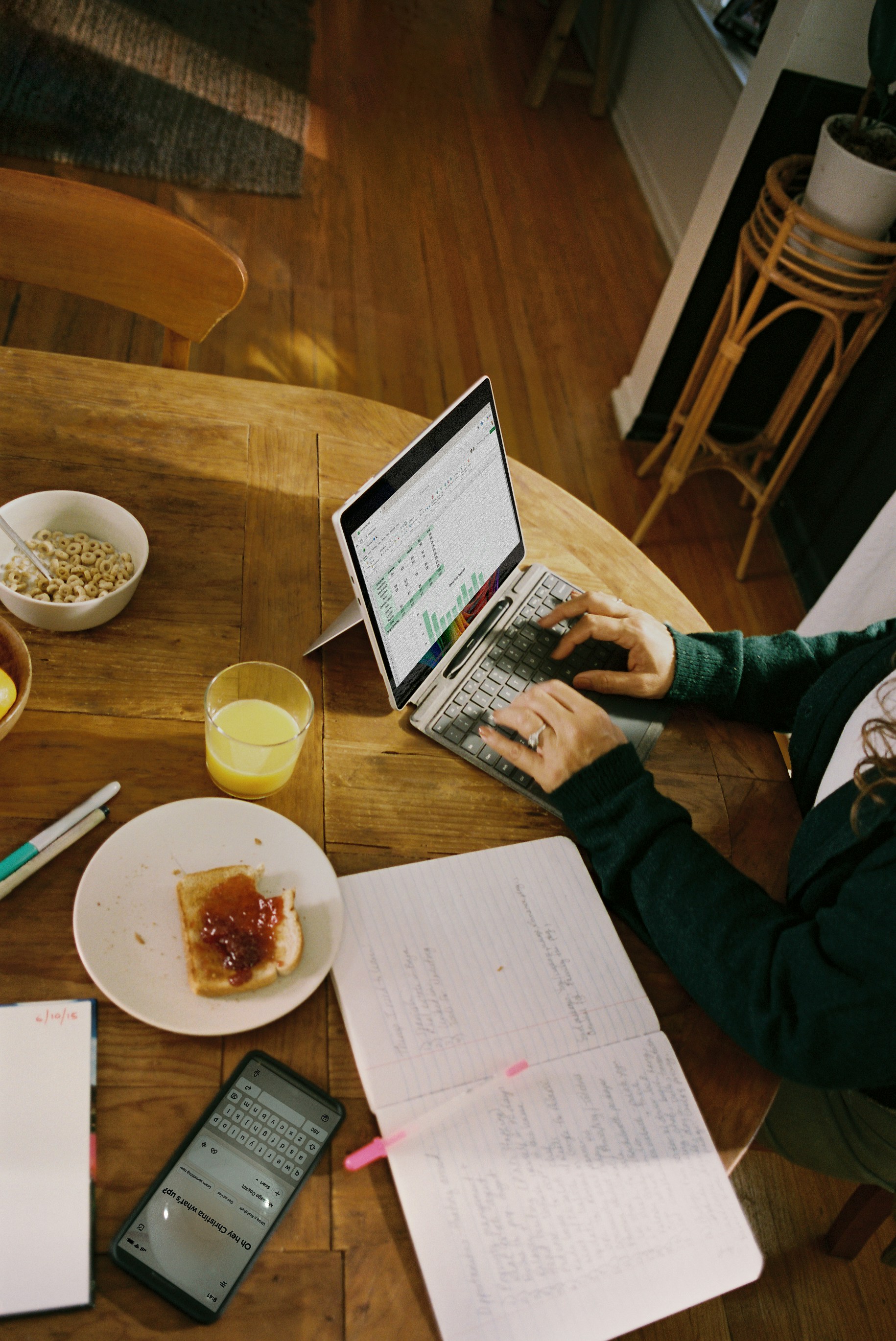 A woman cooking at home, glancing at her tablet on the counter